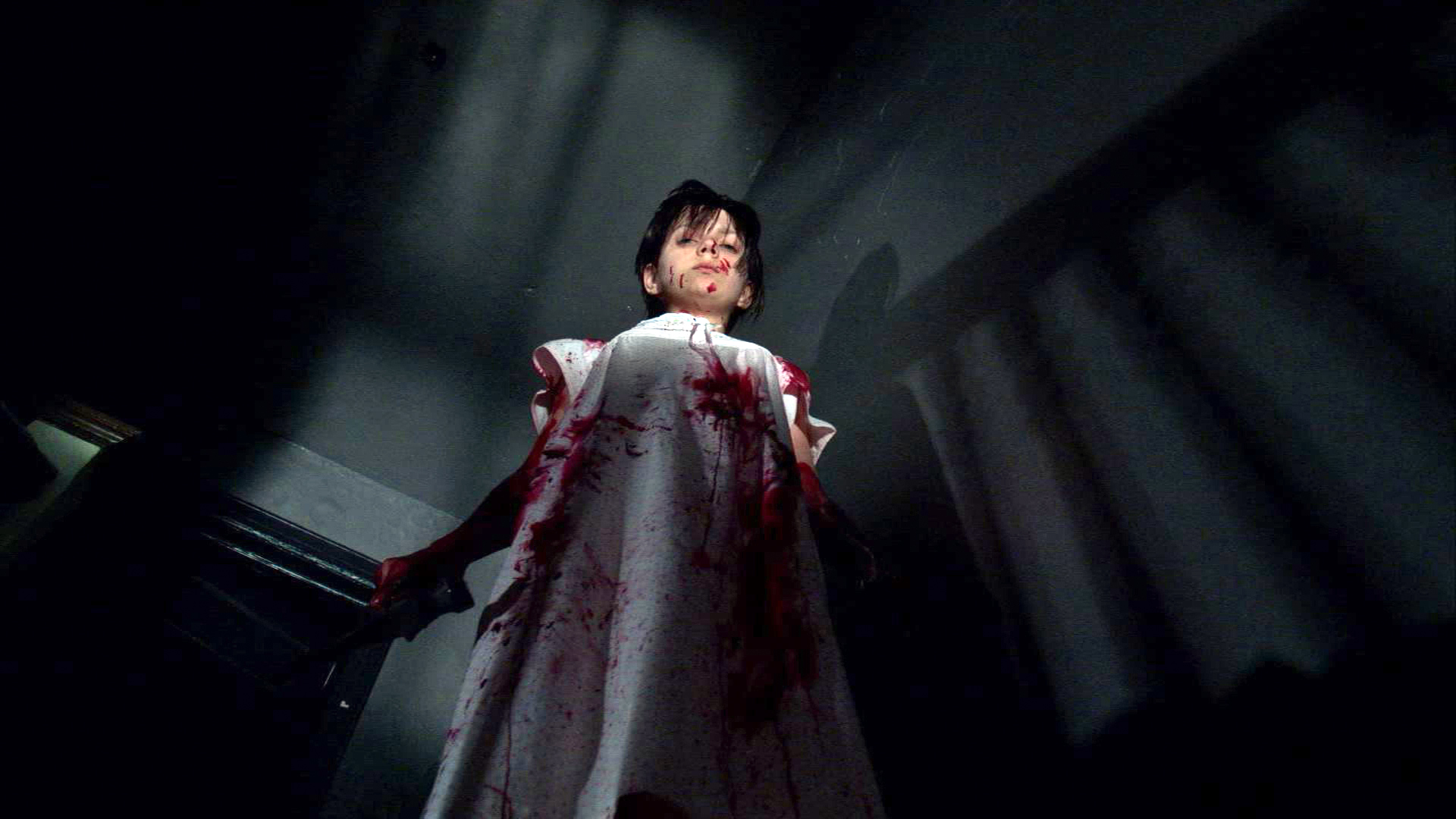 Young Mary stands bloodied above the camera