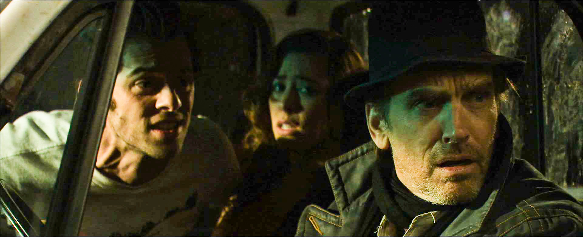 Alex and Gus react inside the van